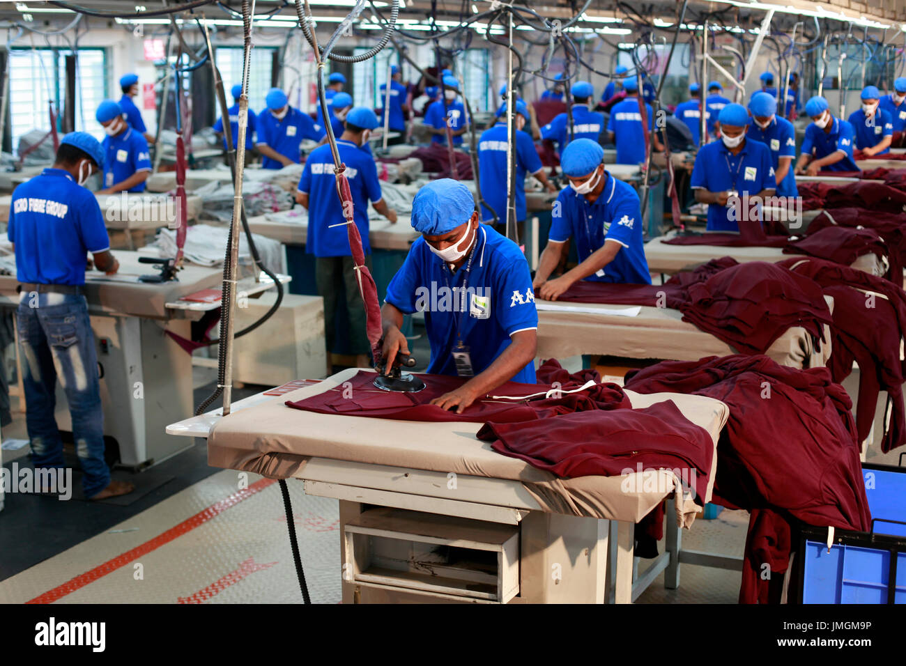 Workers in an iron section of a readymade garment factory at Stock