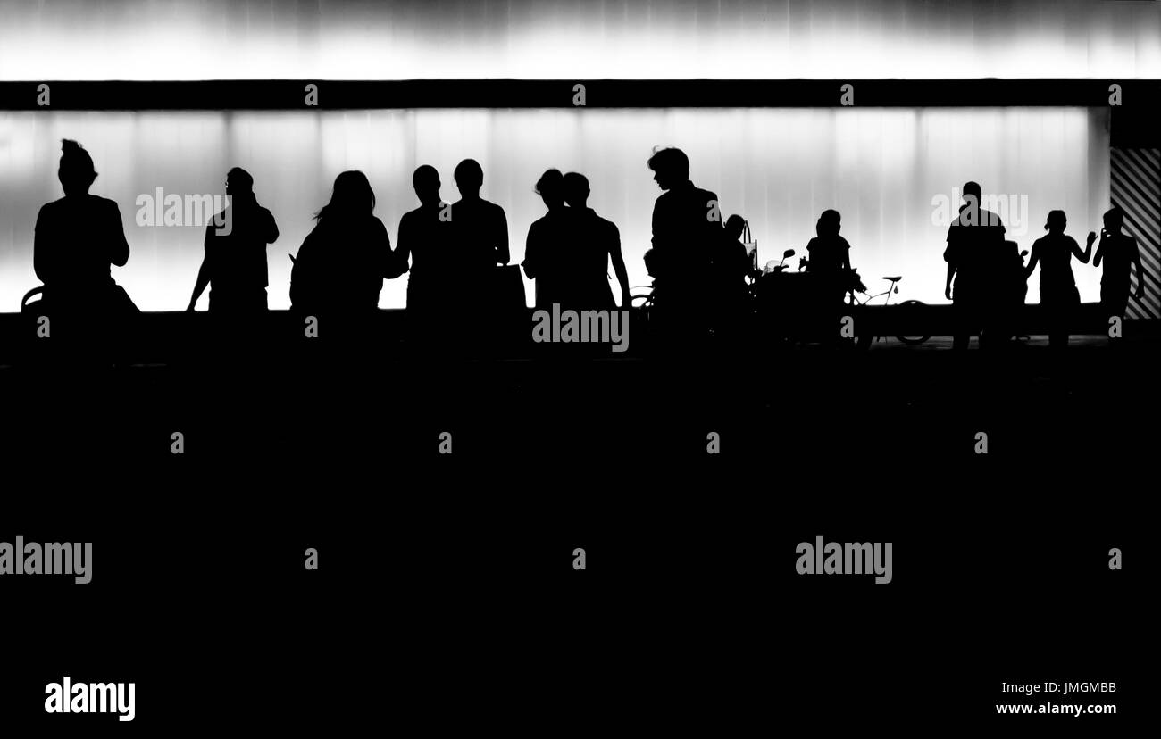 Silhouettes of young people getting out of the building Stock Photo