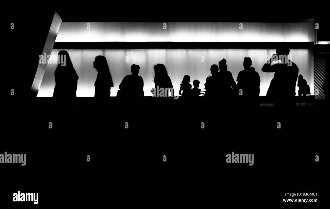 Silhouettes of young people in front of the modern building Stock Photo