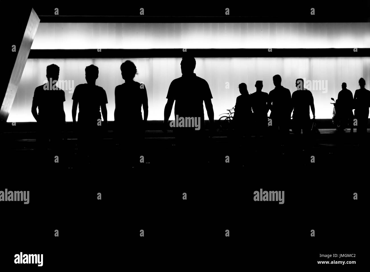 Silhouettes of young people getting out of the modern building Stock Photo