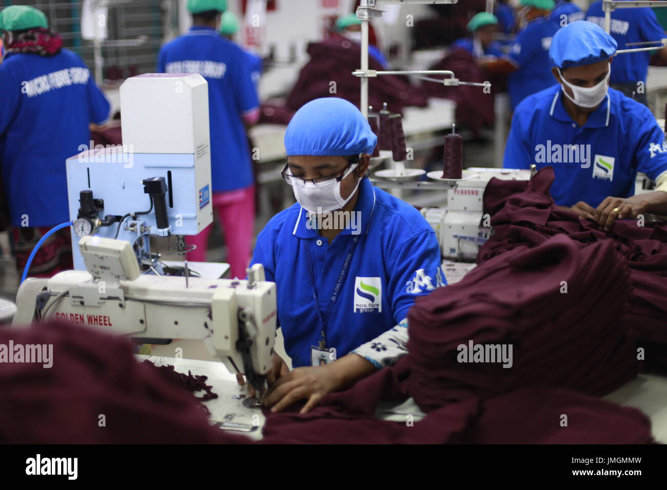 Female workers in a sewing section of a ready-made garment factory at Narayanganj on the outskirts of Dhaka, Bangladesh on June 21, 2014. Bangladesh i Stock Photo