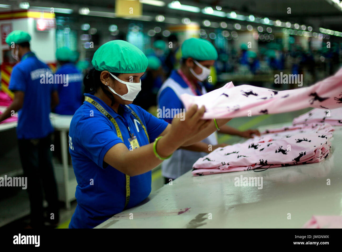Female workers in a ready-made garment factory in Gazipur on the outskirts of Dhaka, Bangladesh on June 22, 2014. Bangladesh is the second largest app Stock Photo