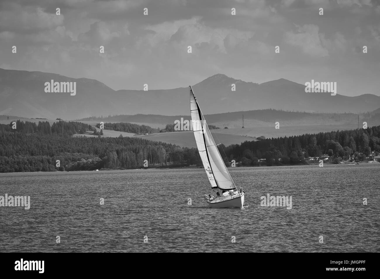 The photo of sailboat on Orava Dam, Slovakia Stock Photo