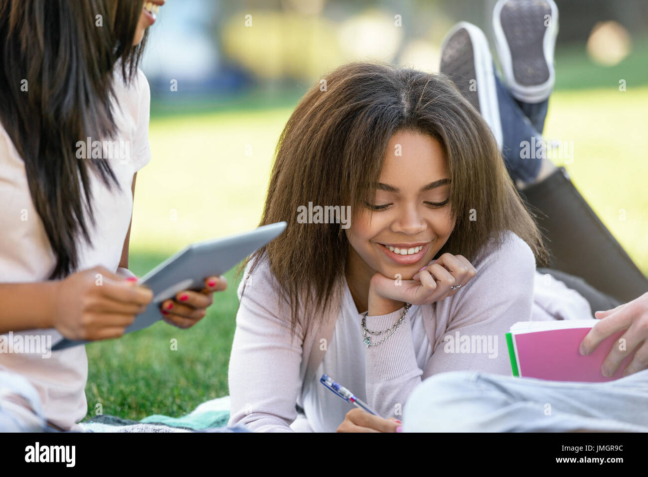 Image of young smiling african woman student studying outdoors. Looking ...