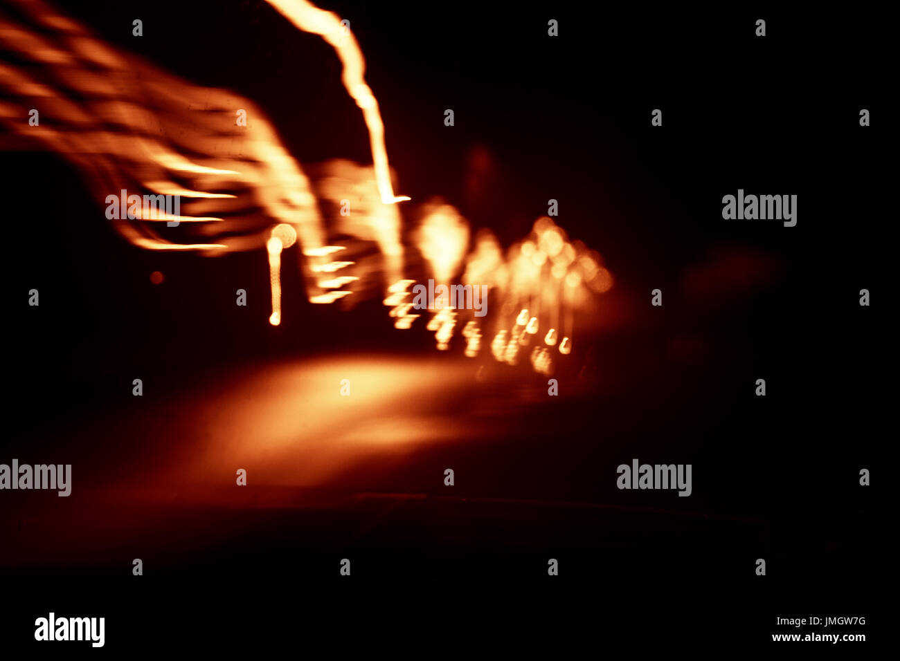 Red abstract trails of light on dark background. Long exposure Stock ...