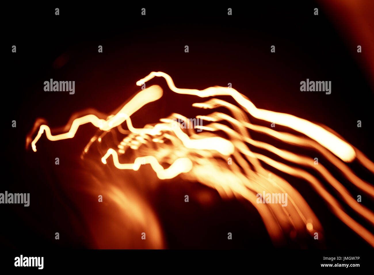 Red abstract trails of light on dark background. Long exposure Stock ...