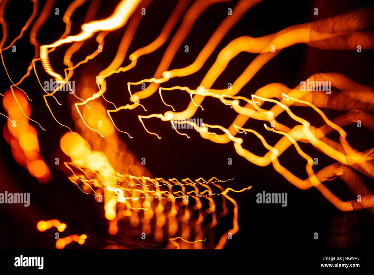 Red abstract trails of light on dark background. Long exposure Stock ...