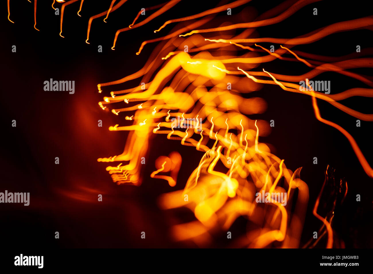 Red abstract trails of light on dark background. Long exposure Stock ...