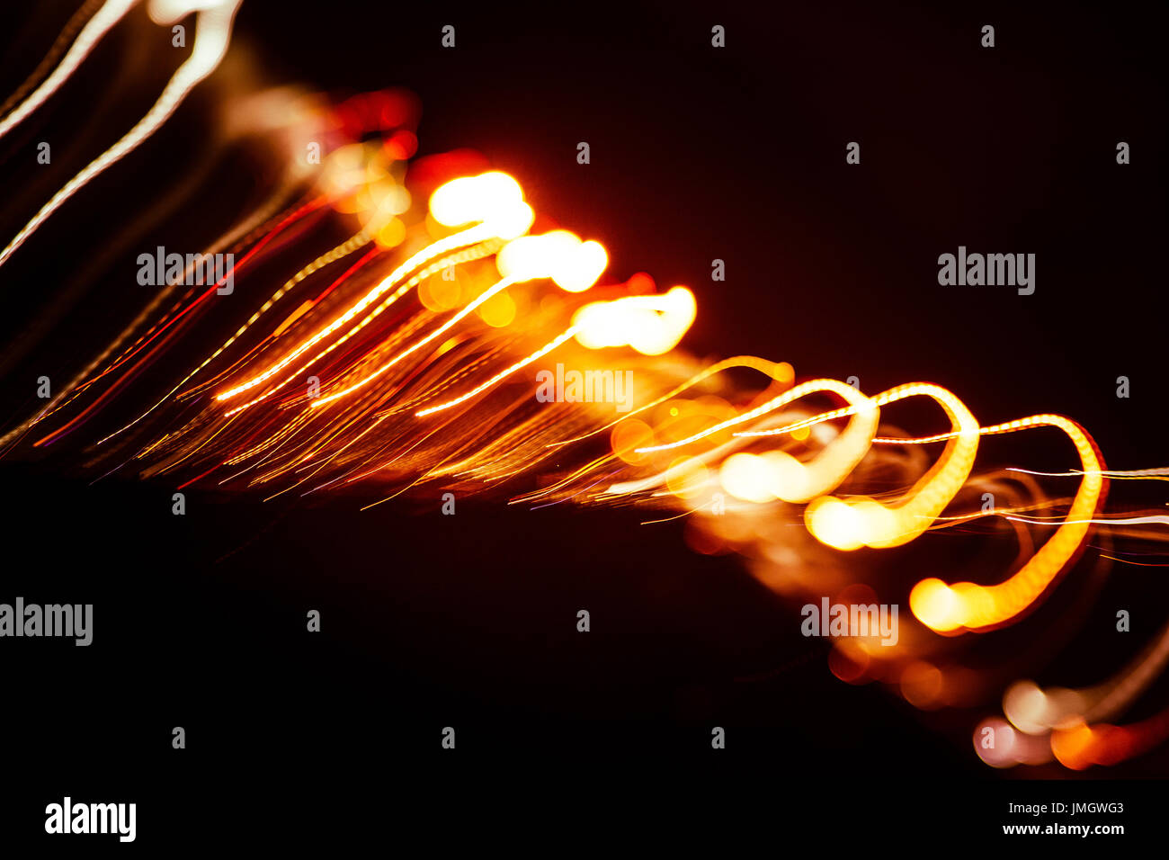 Red abstract trails of light on dark background. Long exposure Stock ...