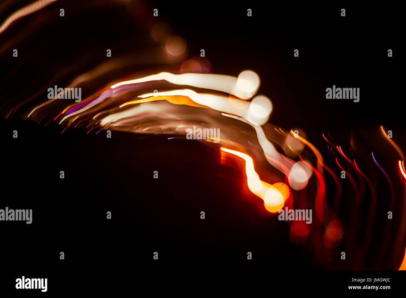 Red abstract trails of light on dark background. Long exposure Stock ...