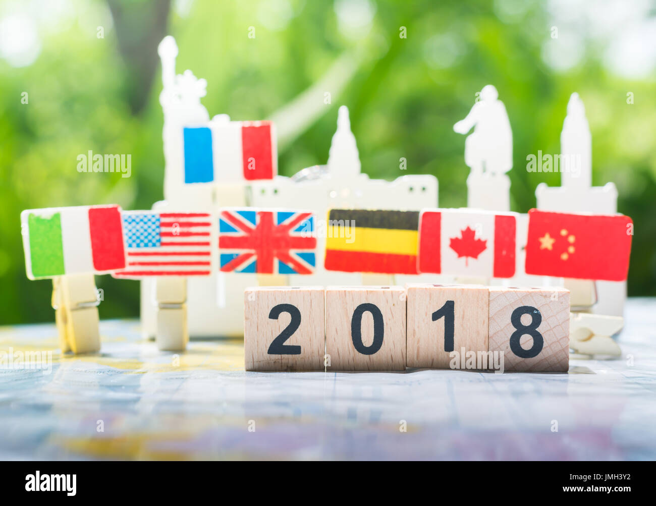 A wooden number 2018 with international flags background on a world map using as happy new year 2018 concept, international cooperation,teamwork. Stock Photo