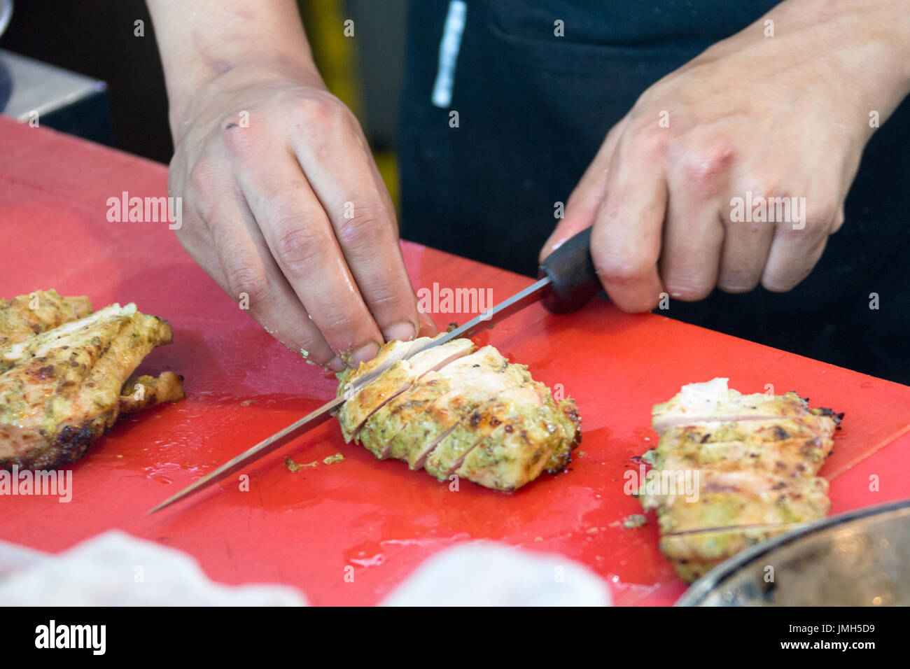 Slicing chicken at The Pot Luck Club, Cape Town, South Africa Stock Photo
