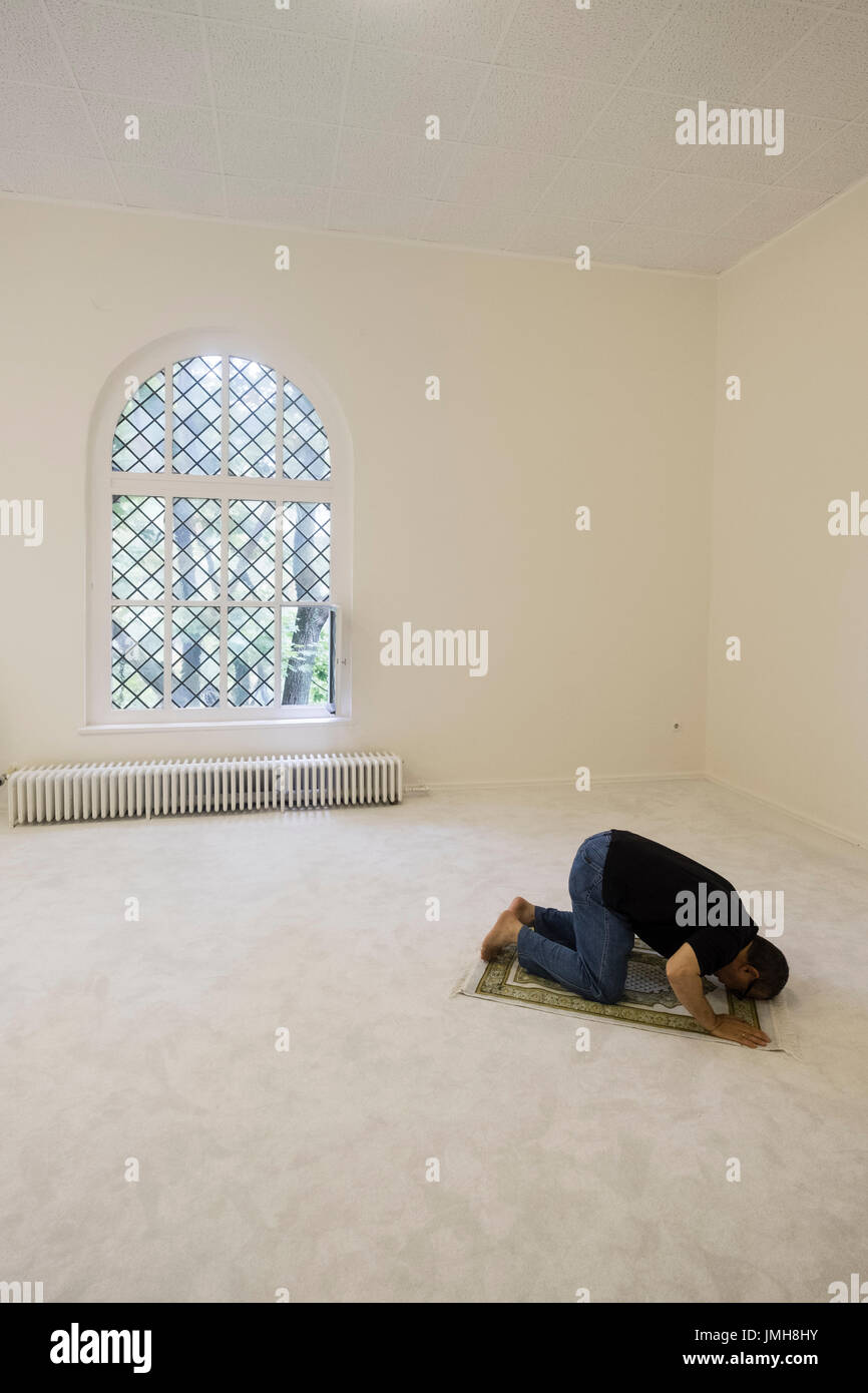 Man praying inside Ibn Rushd-Goethe mosque in St Johannis Church in Berlin. Founded by Seyran Ateş, it is a liberal mosque open to both men and women. Stock Photo