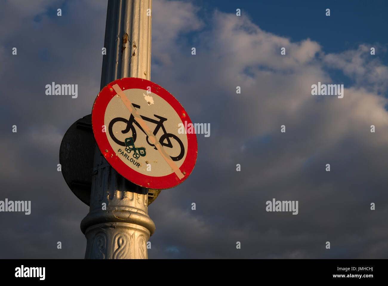 Old warning sign on lampost Stock Photo