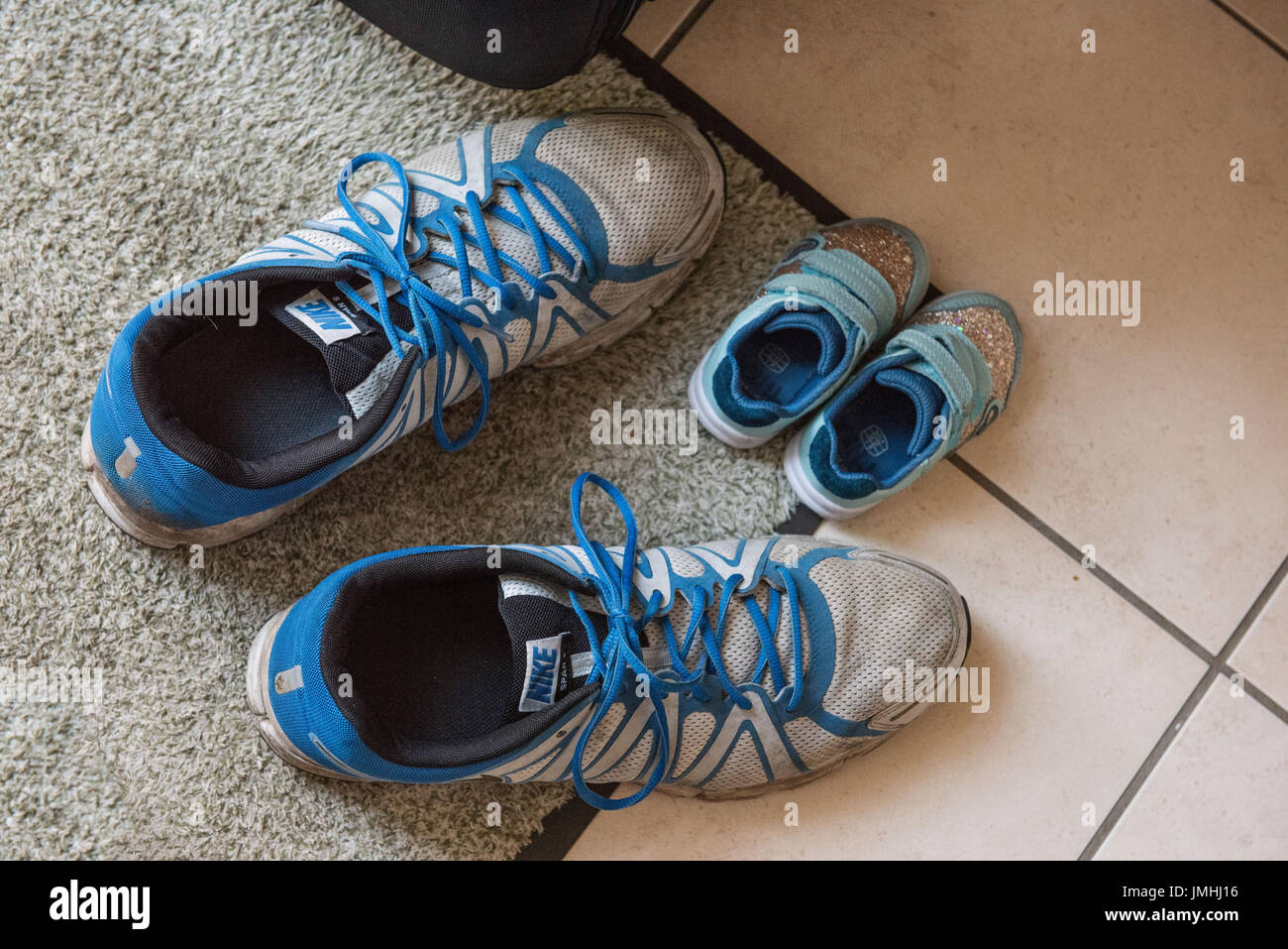 Little and Large, Childs and Adults Trainers Stock Photo