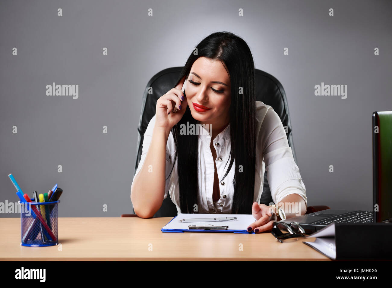 Adult young pretty business woman working at her office Stock Photo - Alamy
