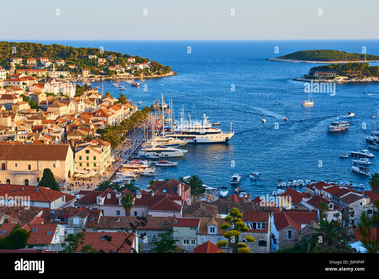 Amazing sunset over Hvar city and bay with yachts, Hvar island, Croatia ...