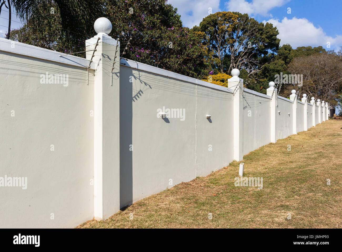 Boundary Wall Electrified Fence for security. Stock Photo