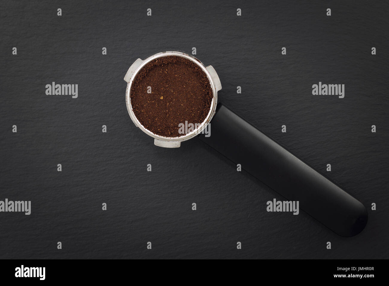 Espresso filter holder for coffee machine on Black background with copy