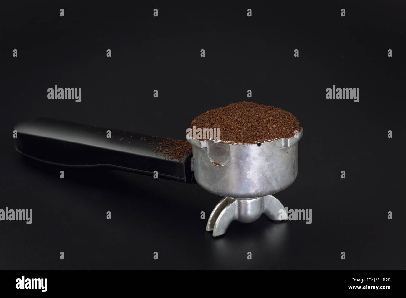 Espresso filter holder for coffee machine on Black background with copy