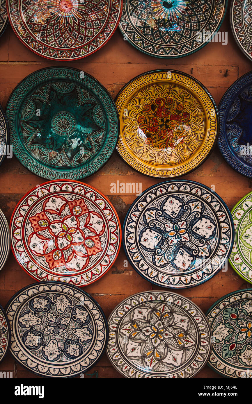 Traditional Moroccan handmade plates hanging on a wall. Stock Photo