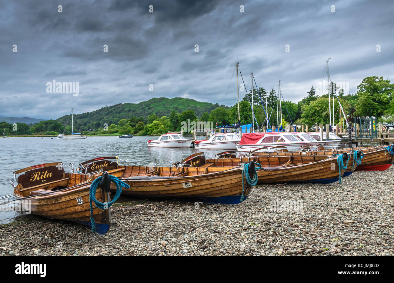 Wooden boats on the shores of Lake Windermere by the Ambleside Pier Stock Photo