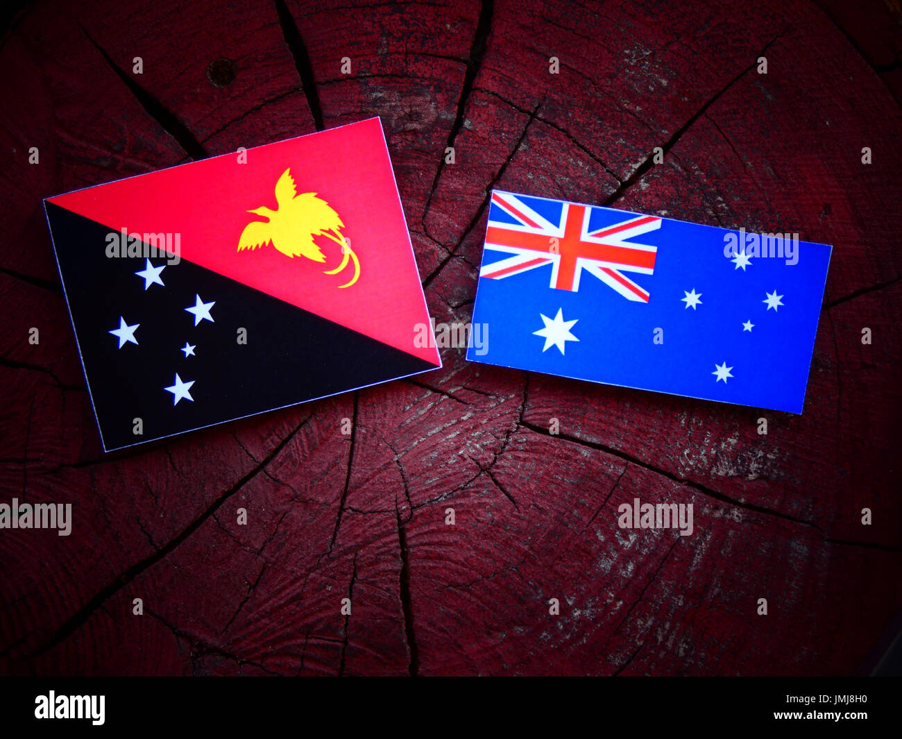 Papua New Guinea flag with Australian flag on a tree stump isolated Stock  Photo - Alamy