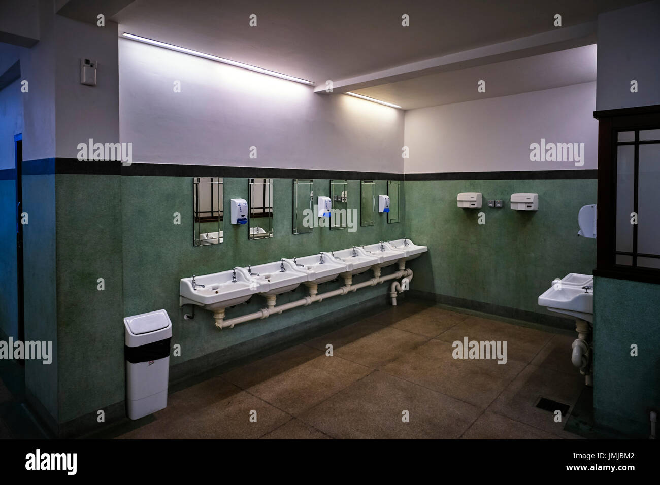 Washbasins in mens toilets in Douglas, Isle of Man Stock Photo