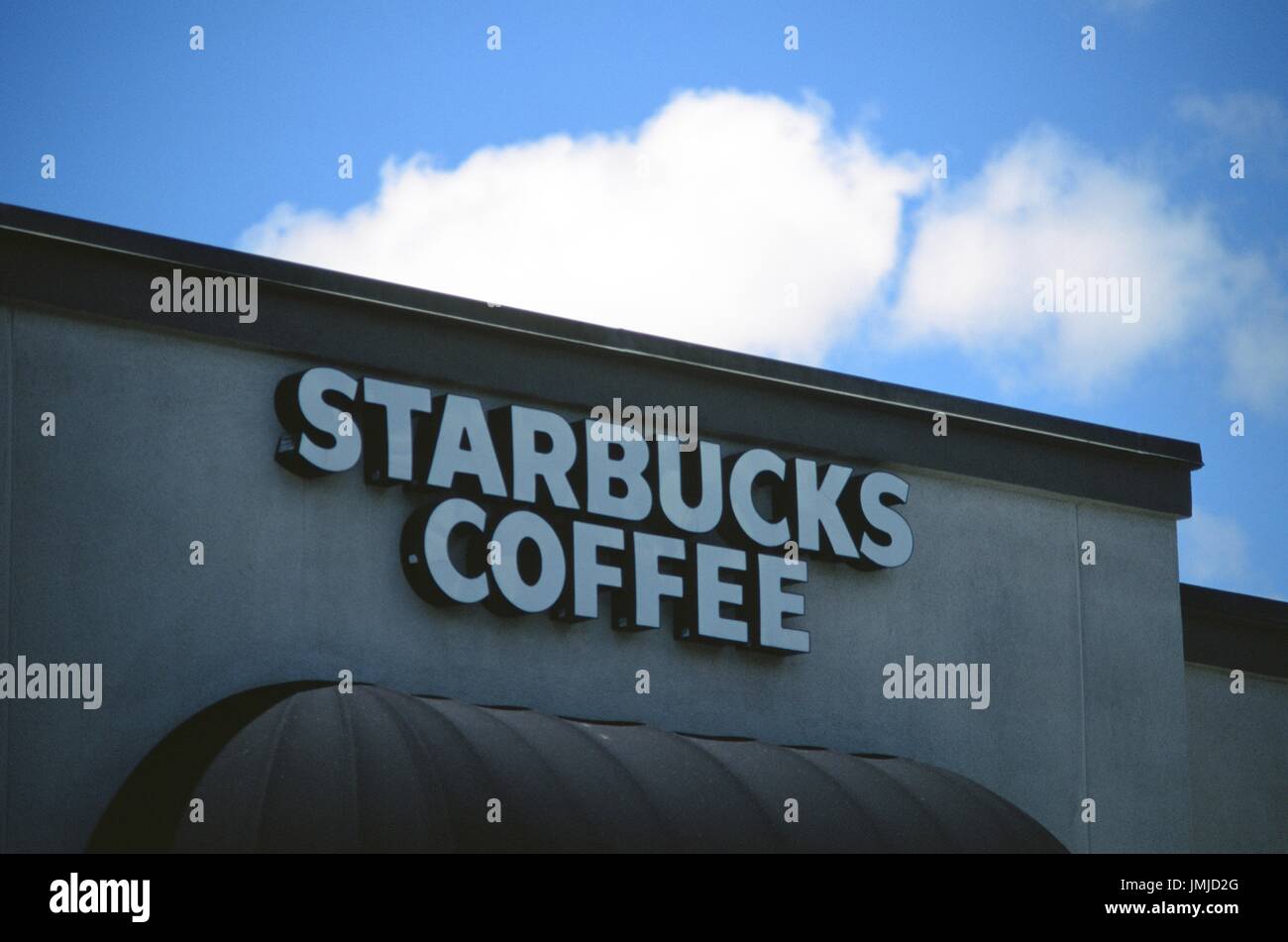 Signage for Starbucks Coffee cafe with cloudy sky in the San Francisco Bay Area suburb of Pleasanton, California, June 11, 2017. Stock Photo