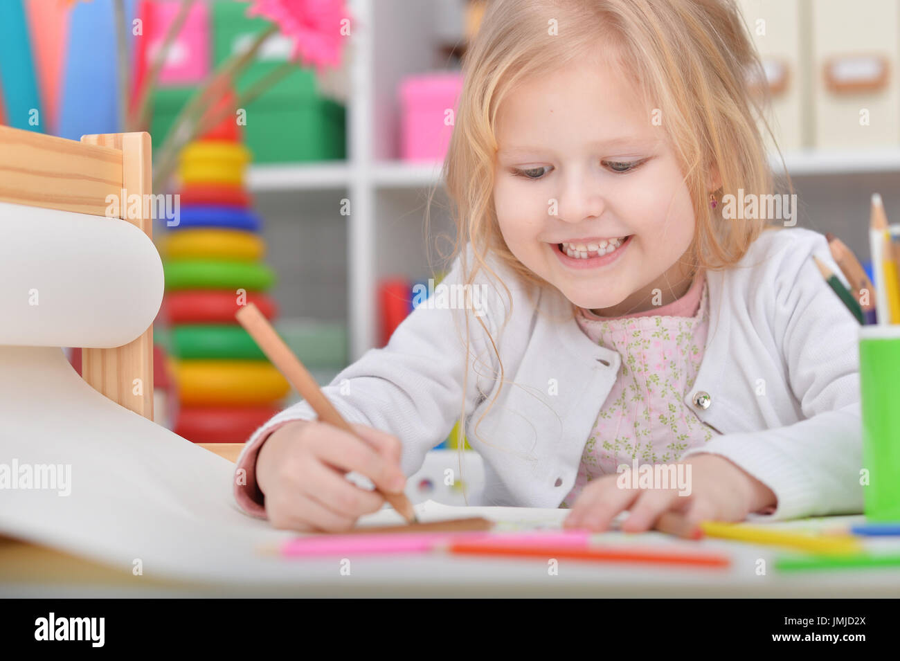 Portrait of a cute little girl drawing with pencil Stock Photo - Alamy