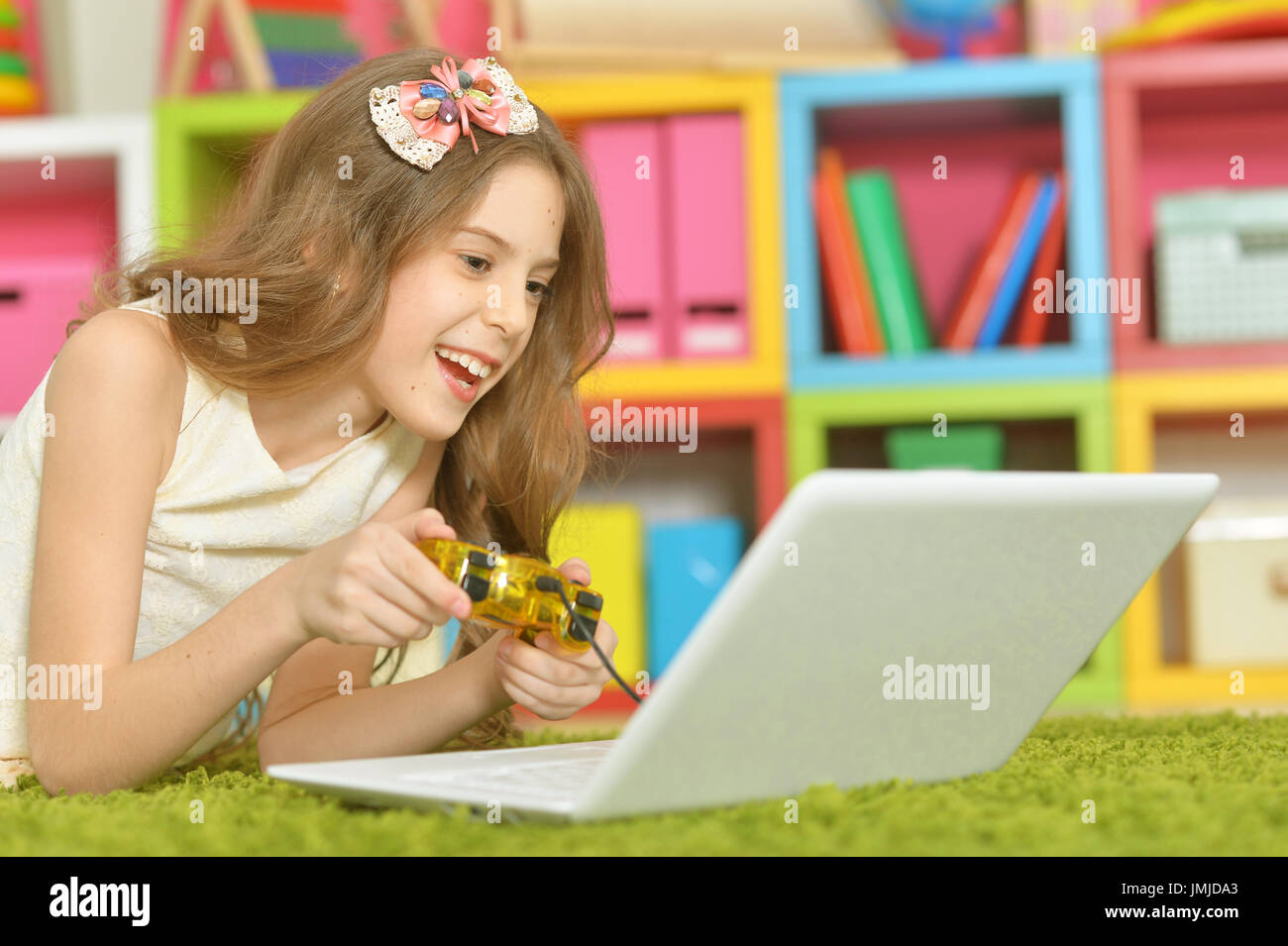 Portrait of adorable little girl using modern laptop Stock Photo - Alamy