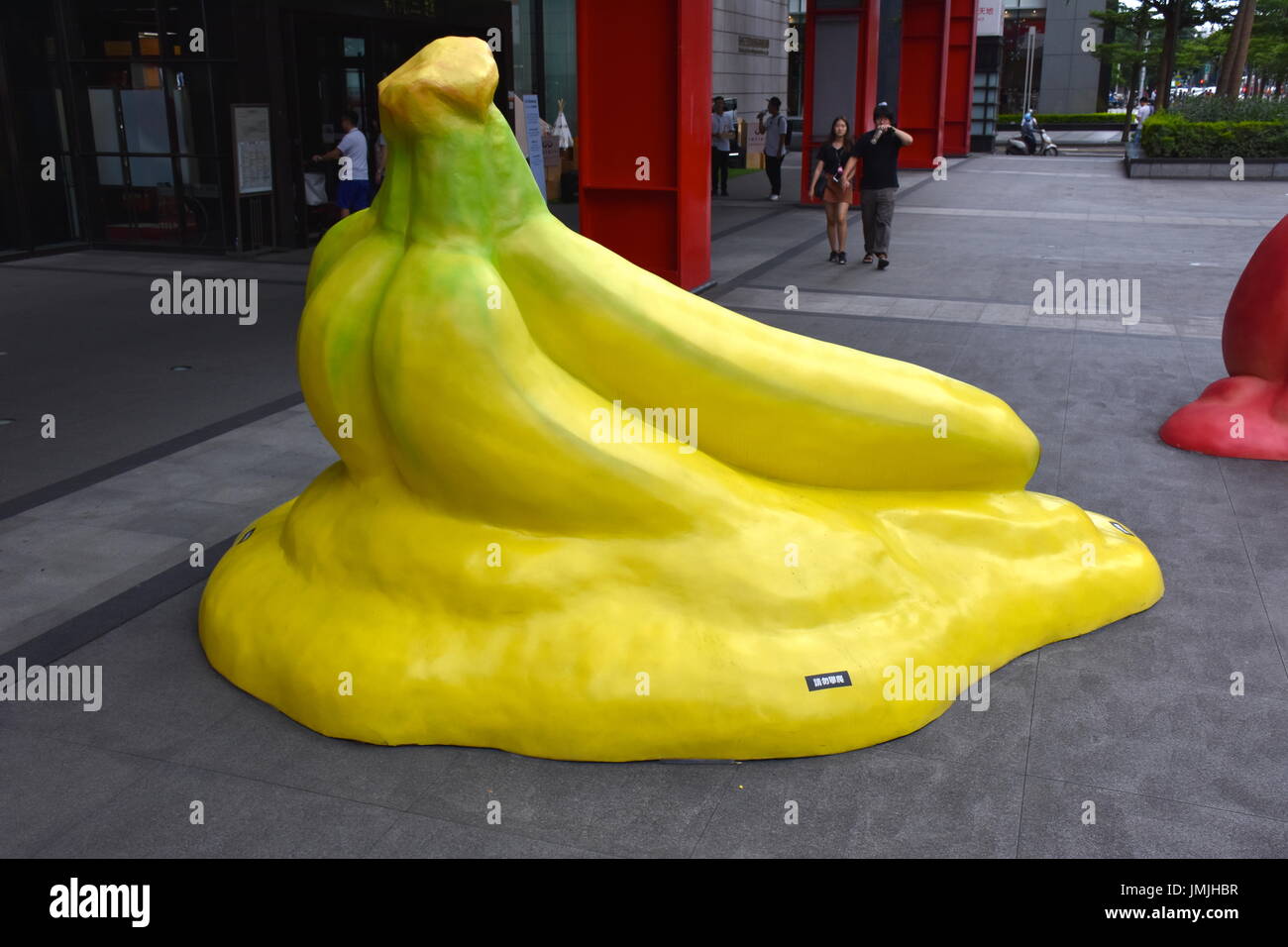 Giant bananas sculpture sits in front of shopping mall for people to