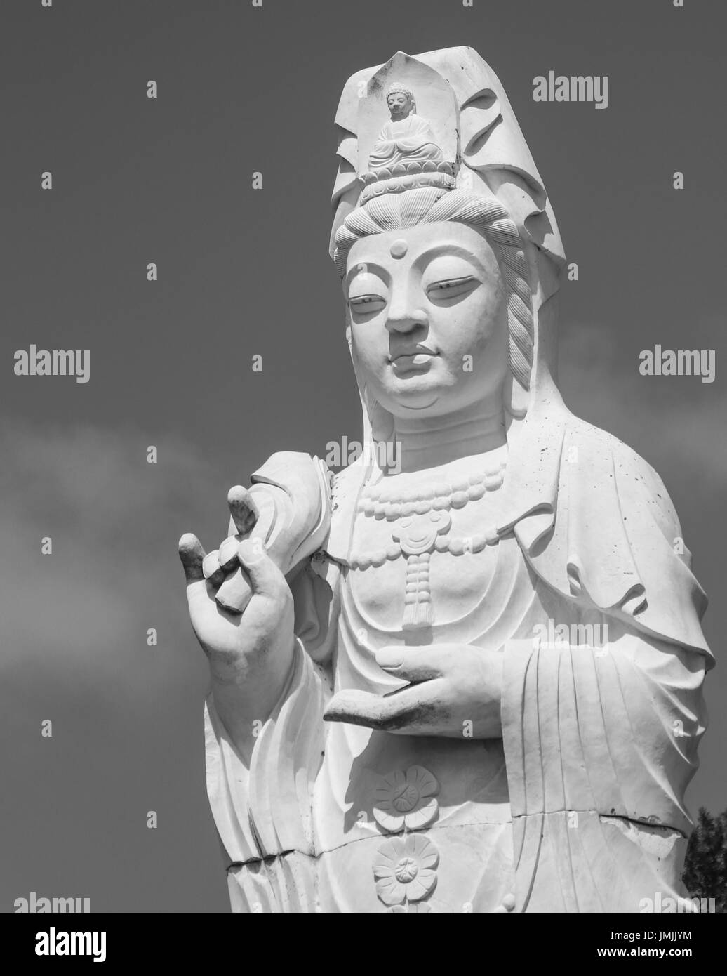 Stone statue of buddha in a zen garden Stock Photo