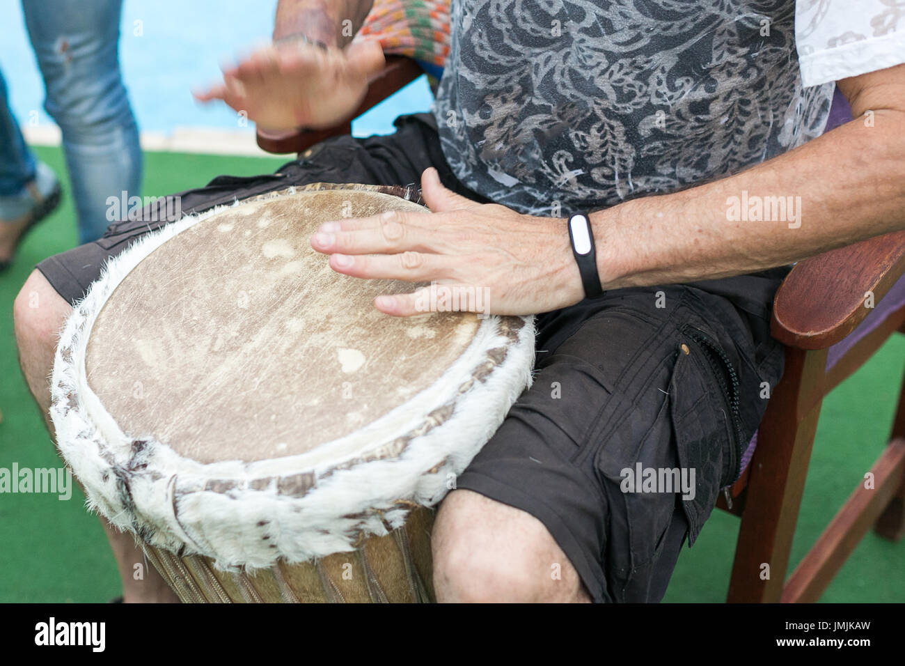 drum, percussion instruments and culture concept closeup on hands of