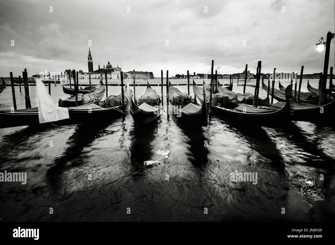 Gondolas tied up in venice canal hi-res stock photography and images ...