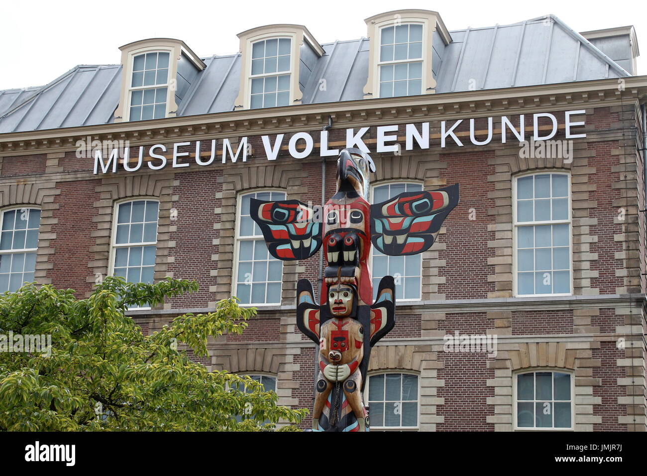 Totem pole in front of Rijksmuseum Volkenkunde (National Museum of Ethnology) in the city of Leiden, Netherlands. Founded in 1837, oldest in Europe. Stock Photo