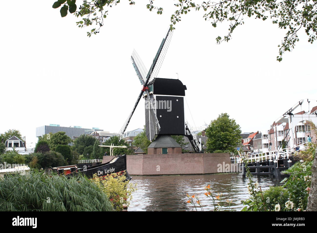 17th century post mill 'De Put' at Galgewater canal in Leiden, Netherlands with Rembrandt bridge on the right. (Both replicas). Stock Photo