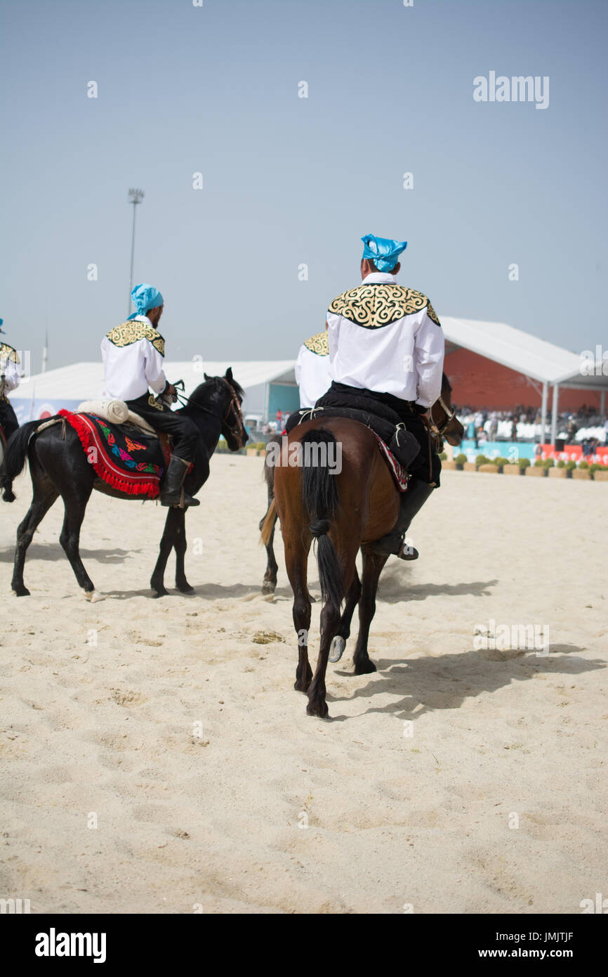 Horseman riding in their ethnic clothes on horseback Stock Photo Alamy