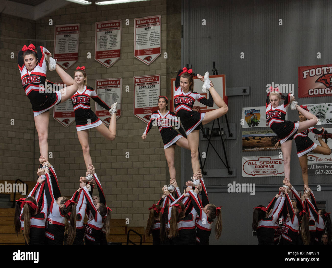 Foothill High School cheerleaders performing at  a game in Palo Cedro, California. Stock Photo
