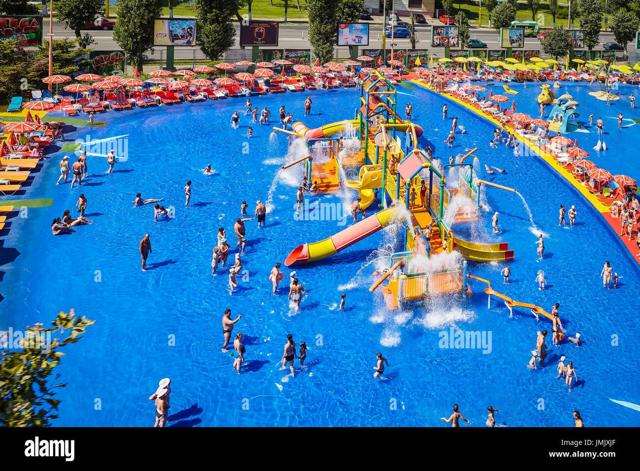 MAMAIA, ROMANIA - AUGUST 27, 2014: Colorful slides and pipes and blue swimming pool at Acqua Park in Mamaia, Romania, with an area of 4000 square fe Stock Photo