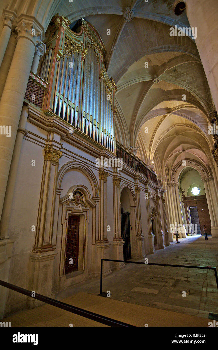 Diagonal vertical caption of one of the lateral naves of Cuenca cathedral, showing gilded archs, ribbed vaults and the back part of the central organ. Stock Photo