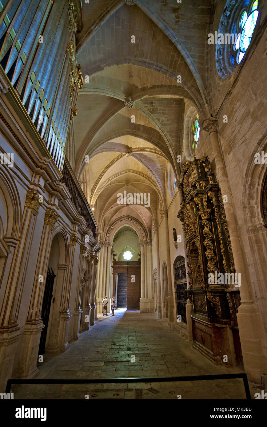 Vertical caption of one of the lateral naves of Cuenca cathedral, showing gilded archs, ribbed vaults and the back part of the central organ. Stock Photo