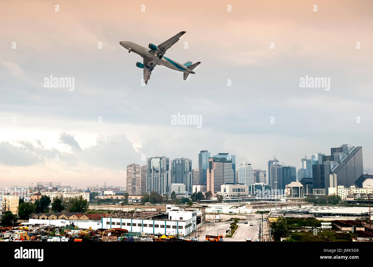 Airplane Flying over buildings Stock Photo Alamy