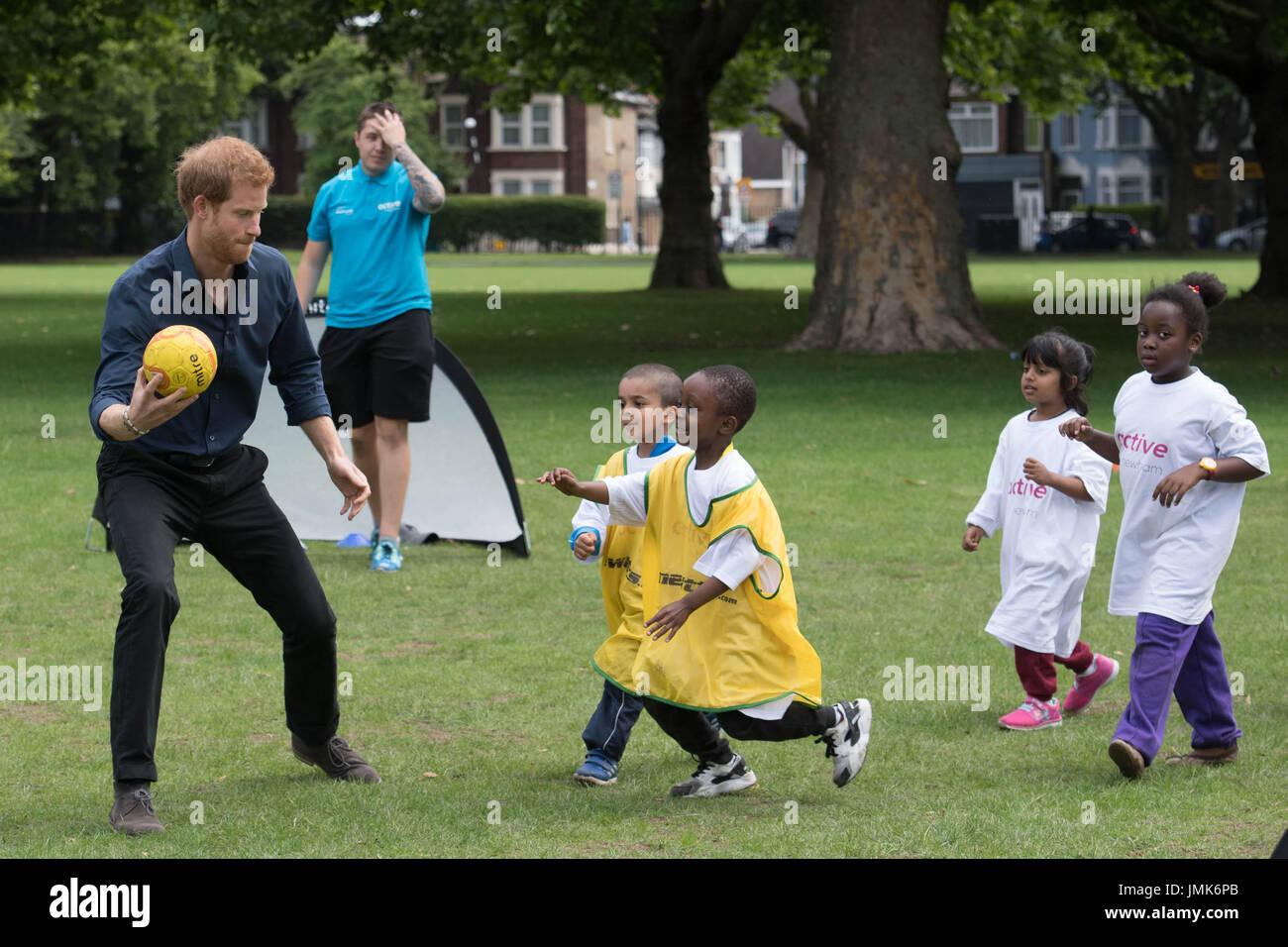 Prince Harry during a visit to a summer holiday activity session run by Newham Council&acirc;€™s leisure trust at Central Park, East Ham, London. Stock Photo