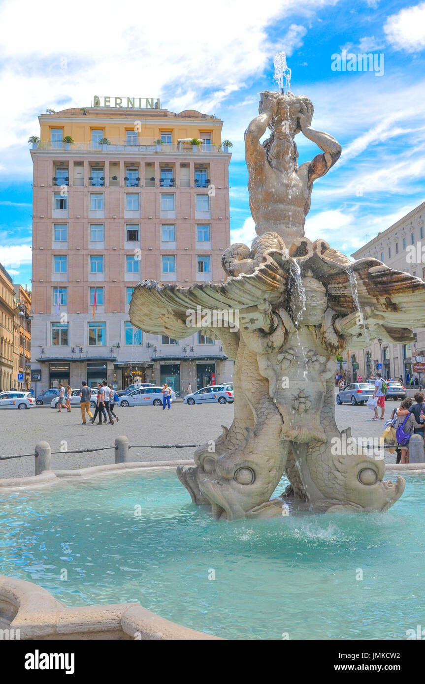 Rome, Italy - June 20, 2016: Tourists admire the architecture of the Triton Fountain in Piazza Barberini, major tourist landmark in Rome, Italy. Stock Photo
