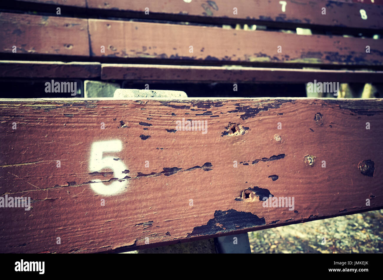 Number five painted on an old wooden seat, conceptual picture with copy space on the right. Stock Photo