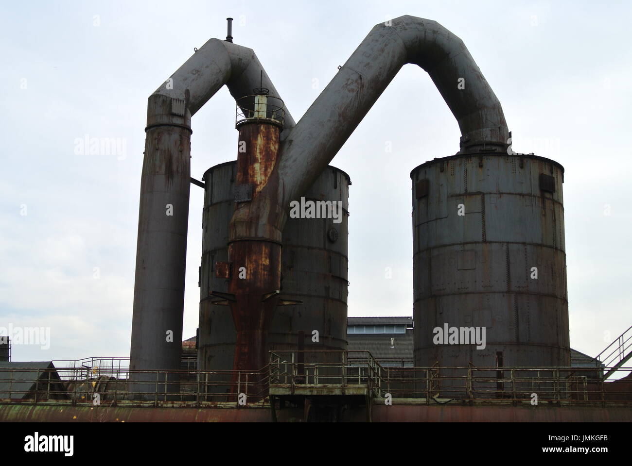 Large pipes and cooling tower at Landschaftspark Duisburg Nord Germany Stock Photo