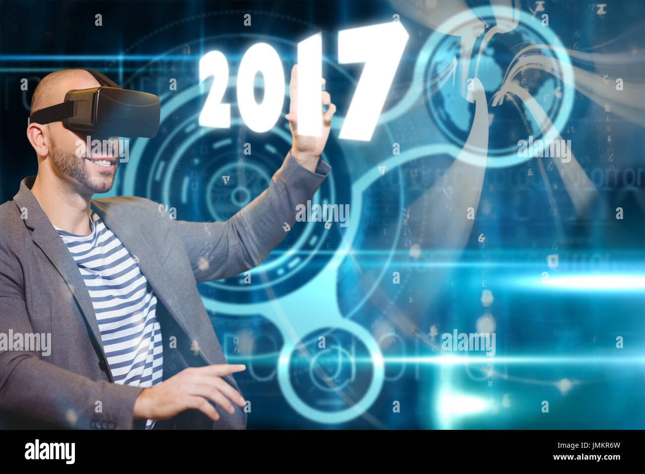 Man with virtual reality simulator against abstract blue pattern Stock Photo