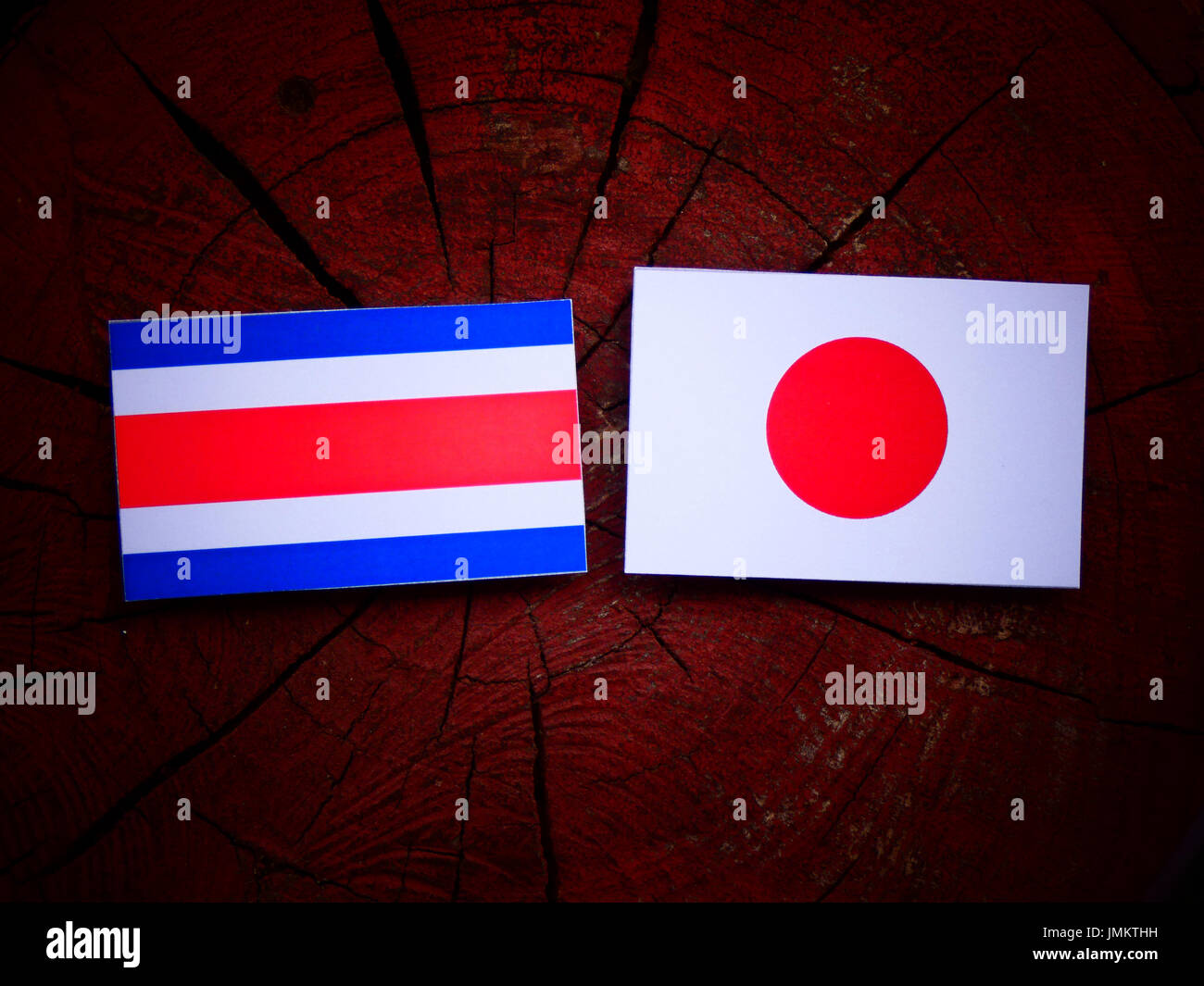 Costa Rican flag with Japanese flag on a tree stump isolated Stock Photo Alamy