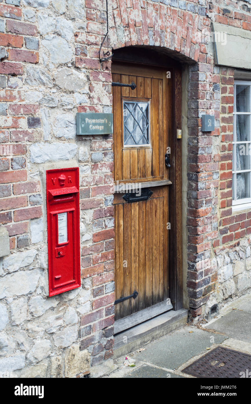 House with very convenient postbox placed in the front of their house next to their letterbox. Stock Photo